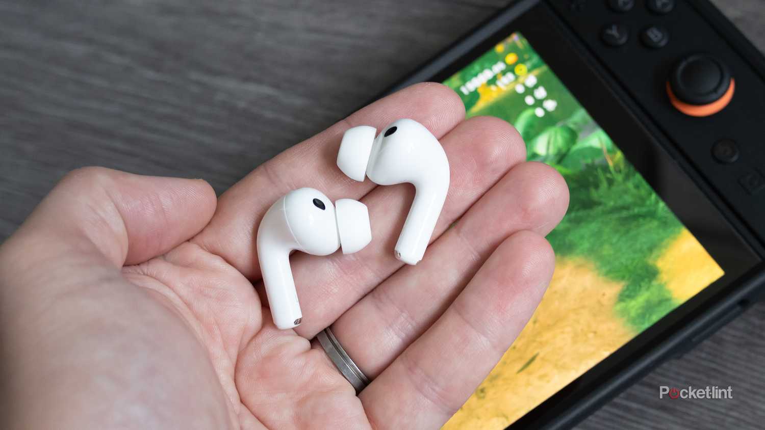 Holding the AirPods Pro 3 wireless earbuds