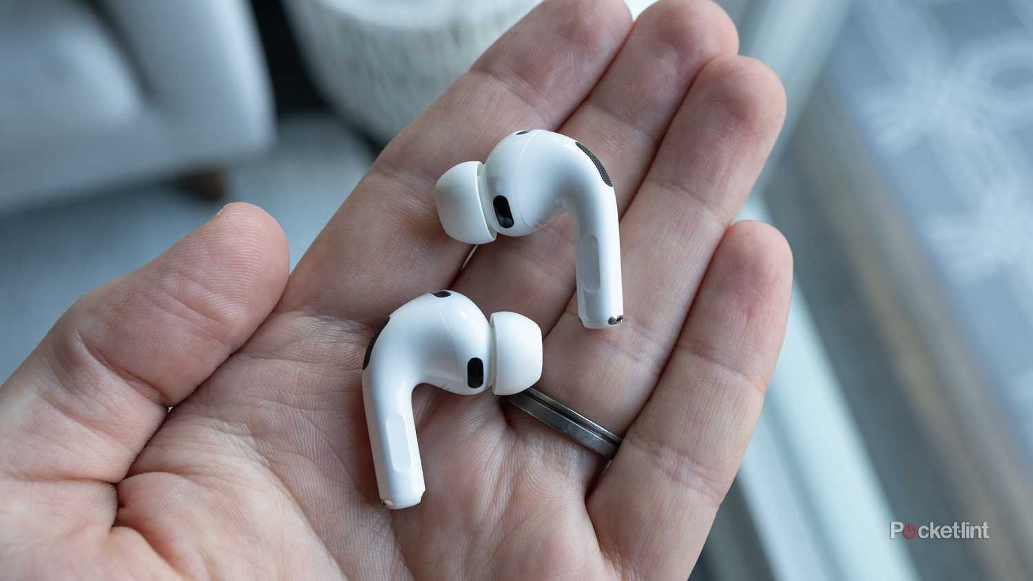 AirPods Pro 3 earbuds in-hand.