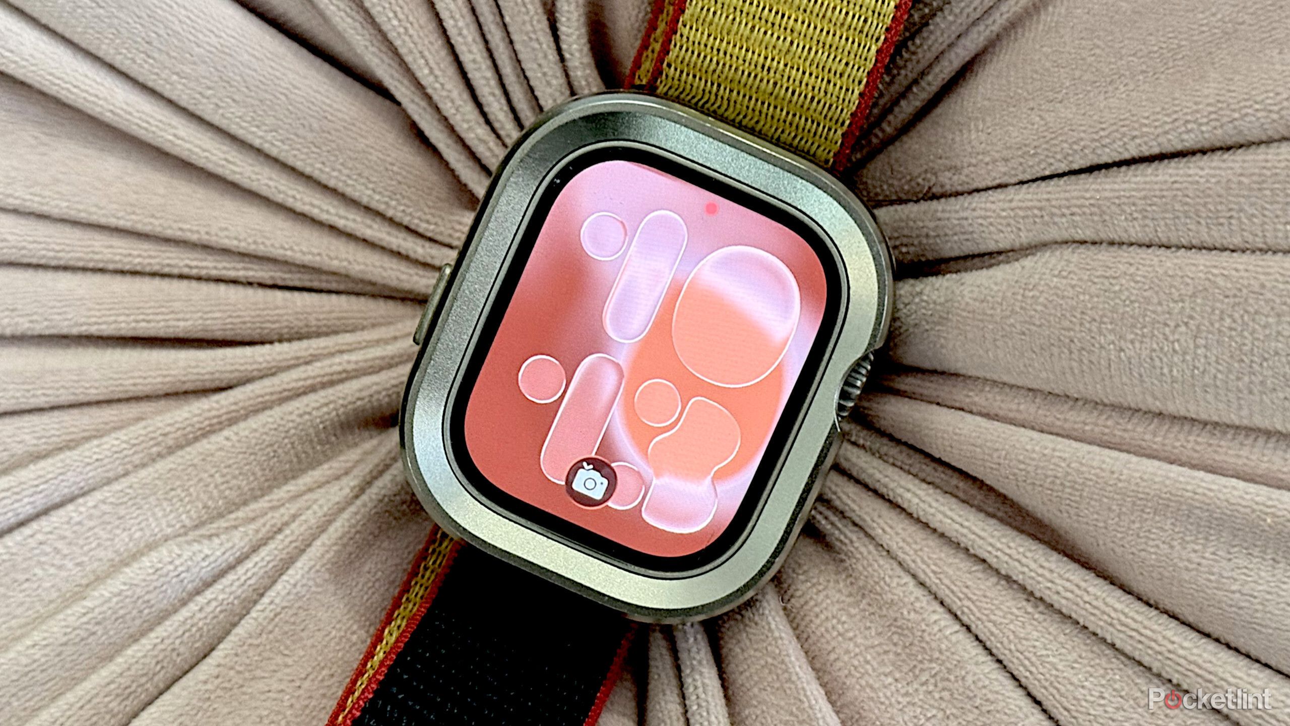 An Apple Watch Ultra 2 on a pillow. 