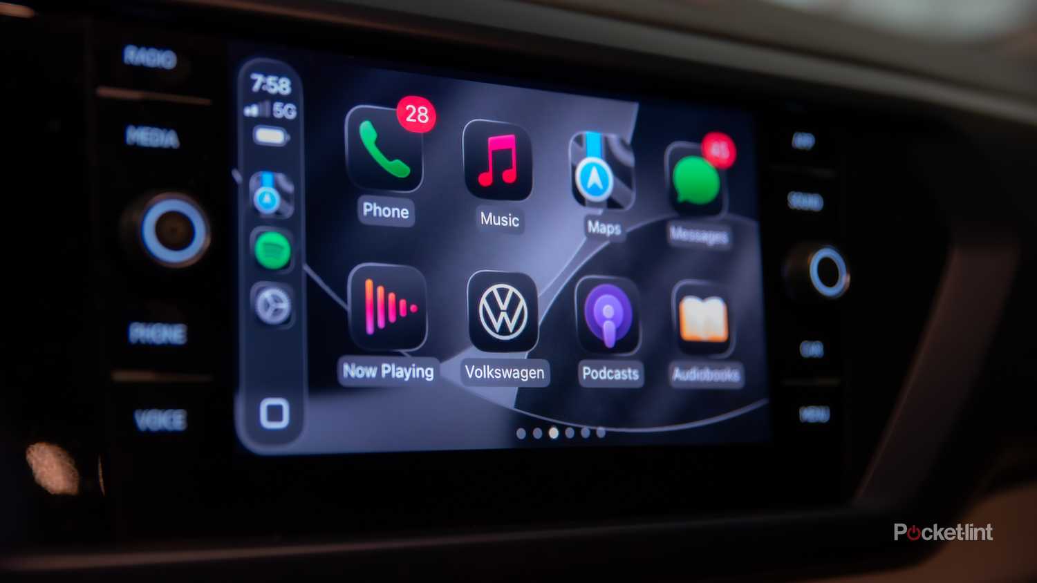 A still photo of Apple CarPlay iOS 26 with apps in dark mode.