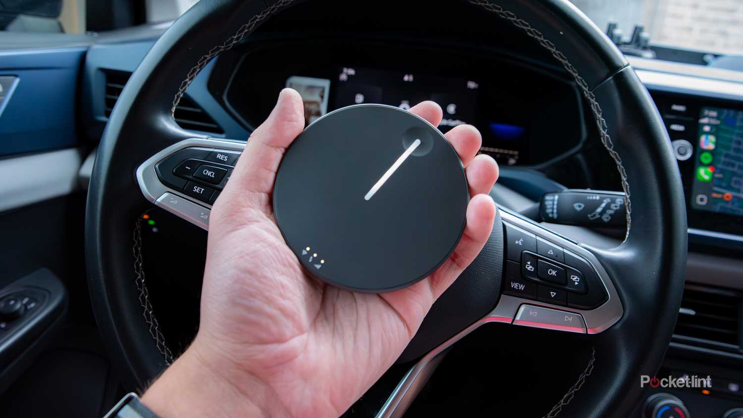 A still photo of a hand holding a Travlfi JourneyGo hotspot. 