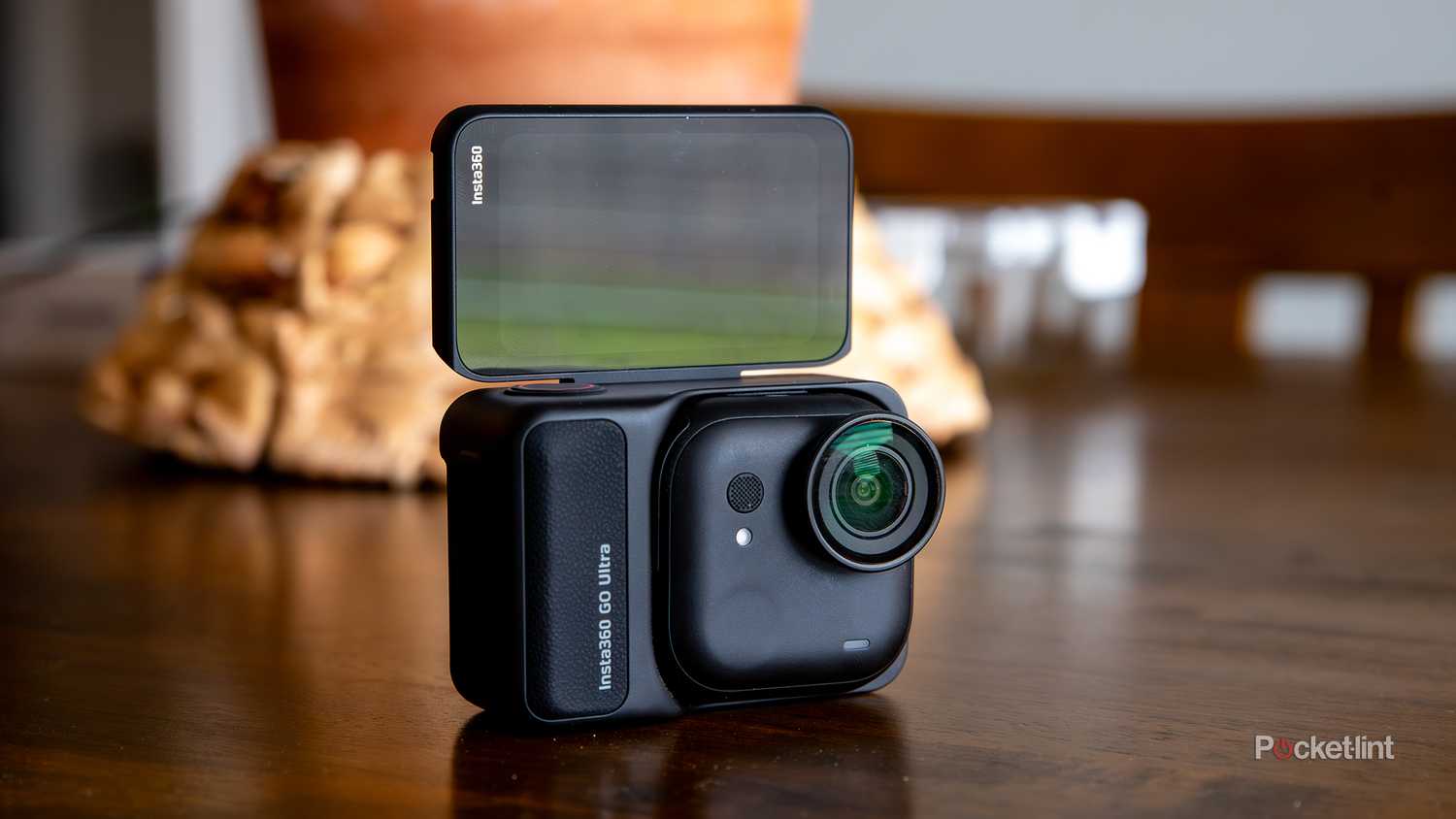 A still photo of the Insta360 GO Ultra with the rear screen flipped to selfie mode.