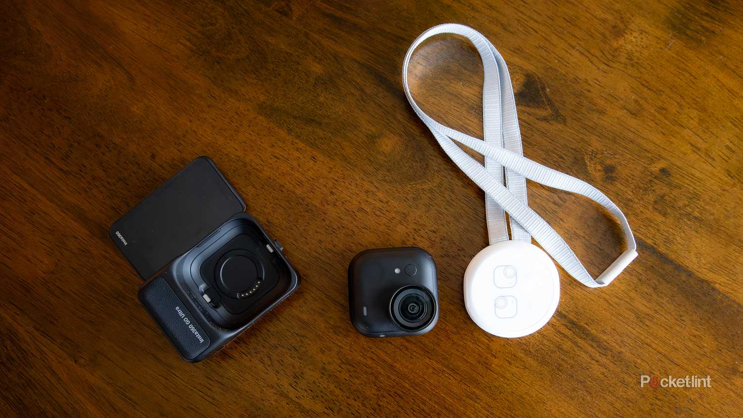 A still photo of the Insta360 GO Ultra and its accompanying magnetic necklace.