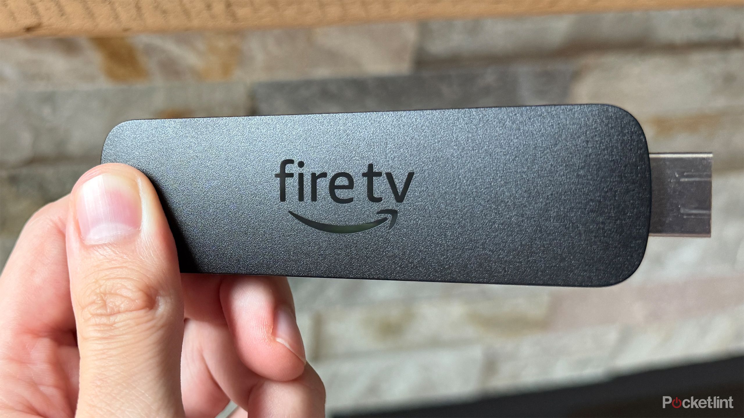 Fire TV Stick in front of fireplace.