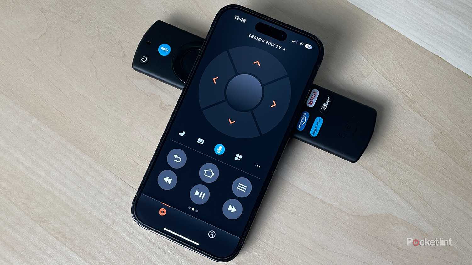 Fire TV app on iPhone next to Alexa Voice remote.