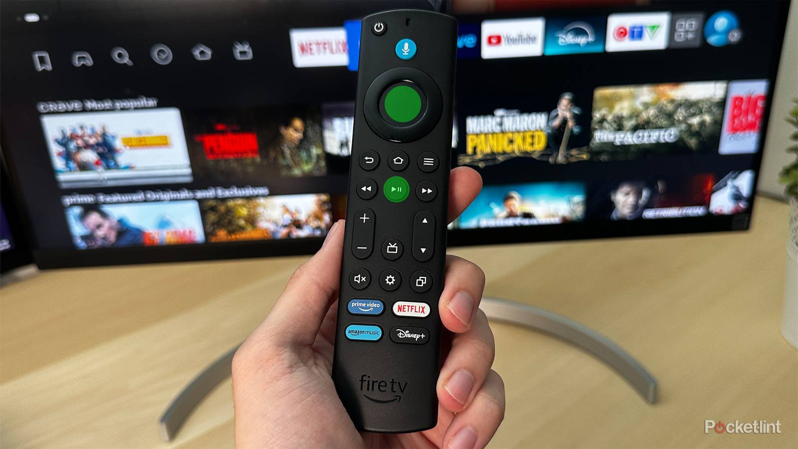 Amazon Fire TV Stick in hand with restart buttons highlighted.