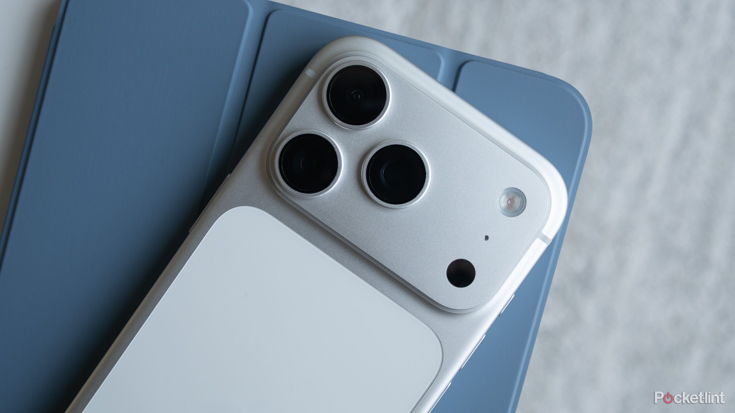 An iPhone 17 Pro sitting on top of an iPad.