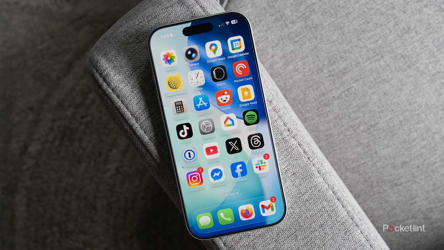 The iPhone 17 sitting on a couch arm