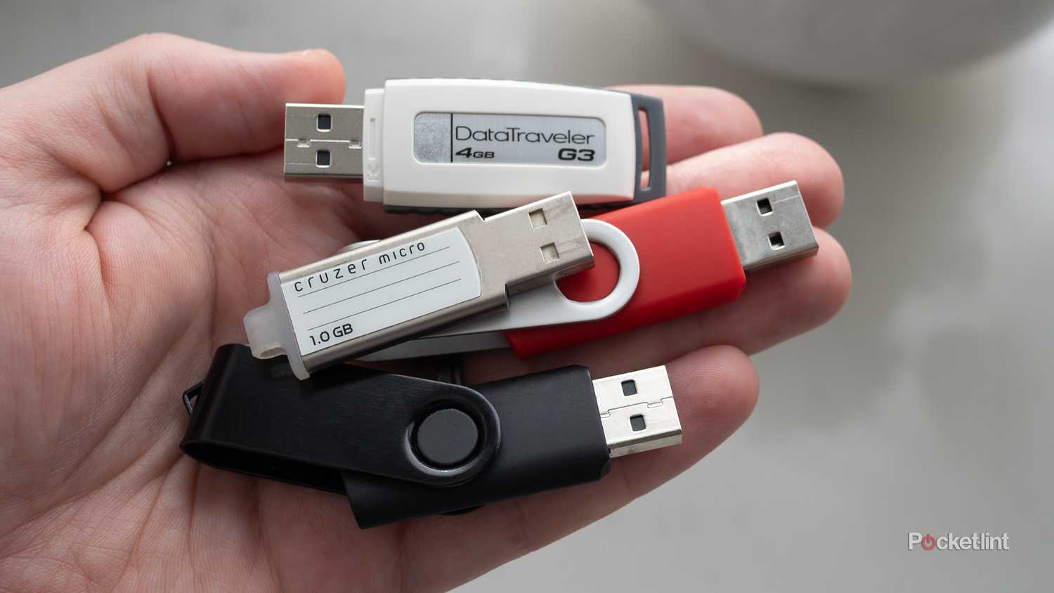 Several old USB keys being held