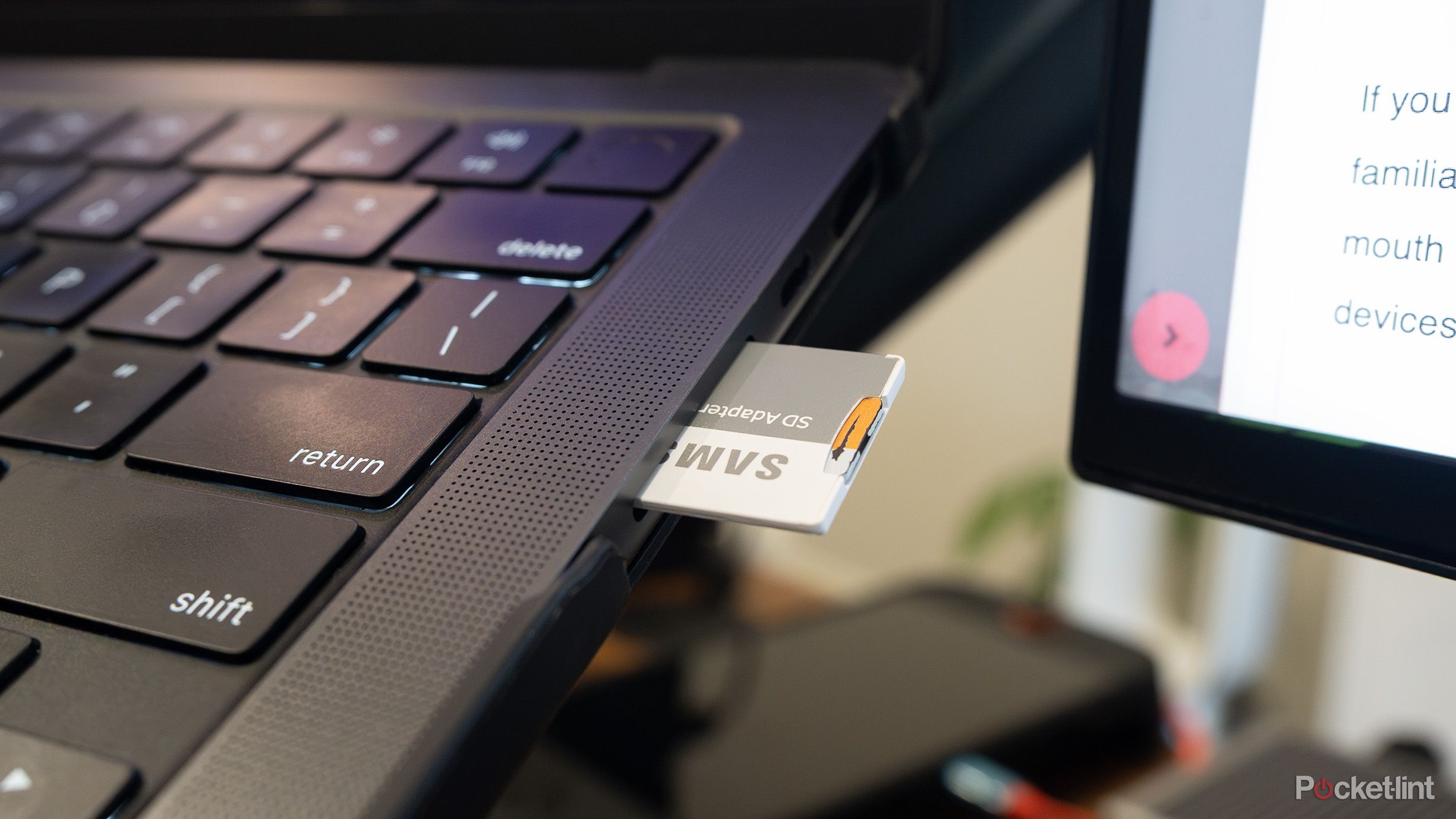 MacBook Pro SD card reader with an SD card in it 