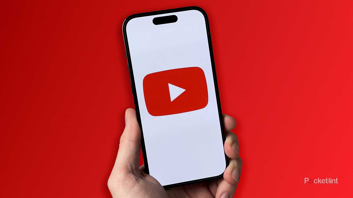 YouTube app on iPhone on red background.