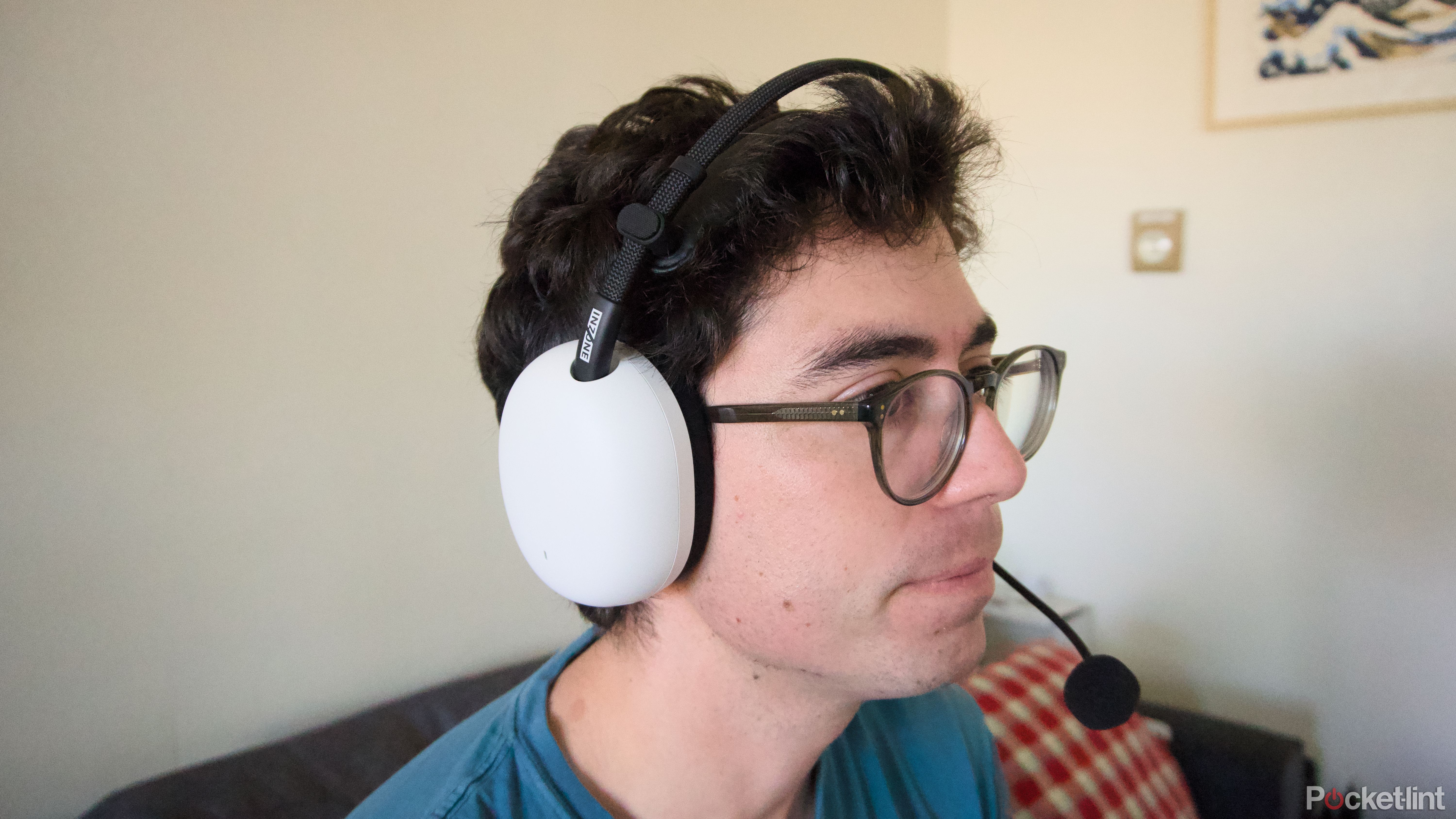 A person wearing a white InZone H9 II gaming headset.