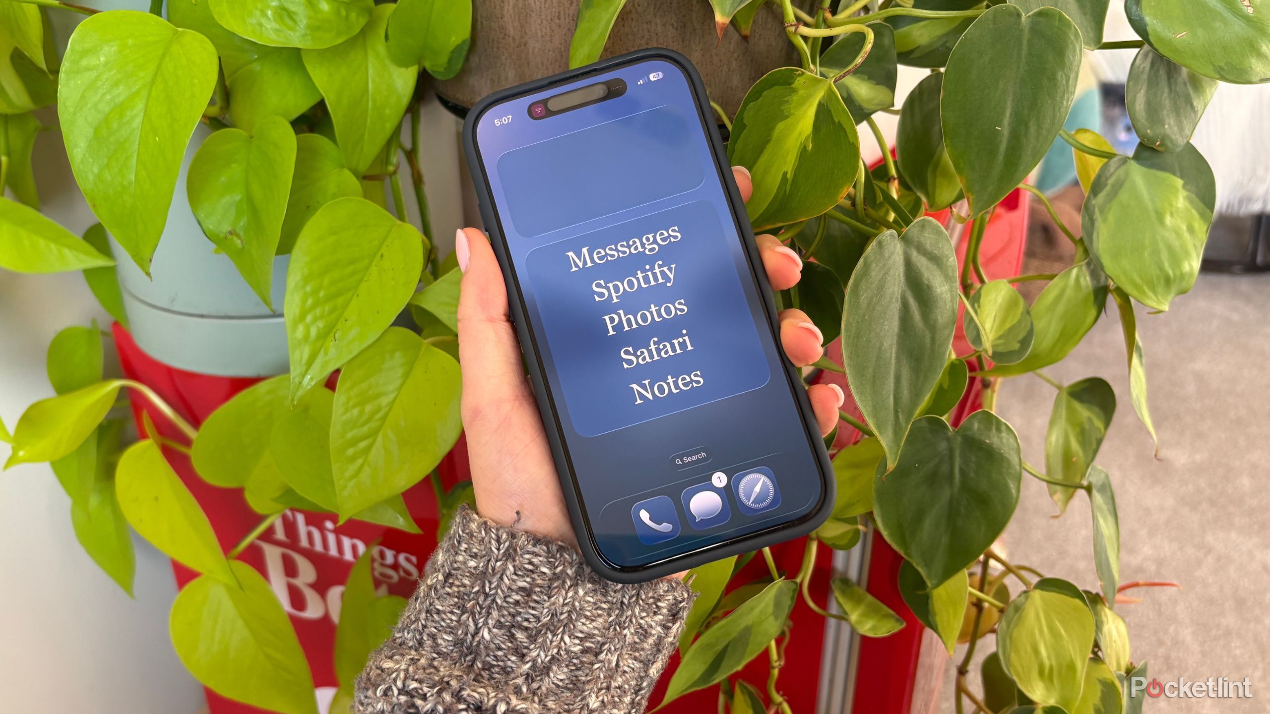 Kelsey holding a dumb iPhone. 