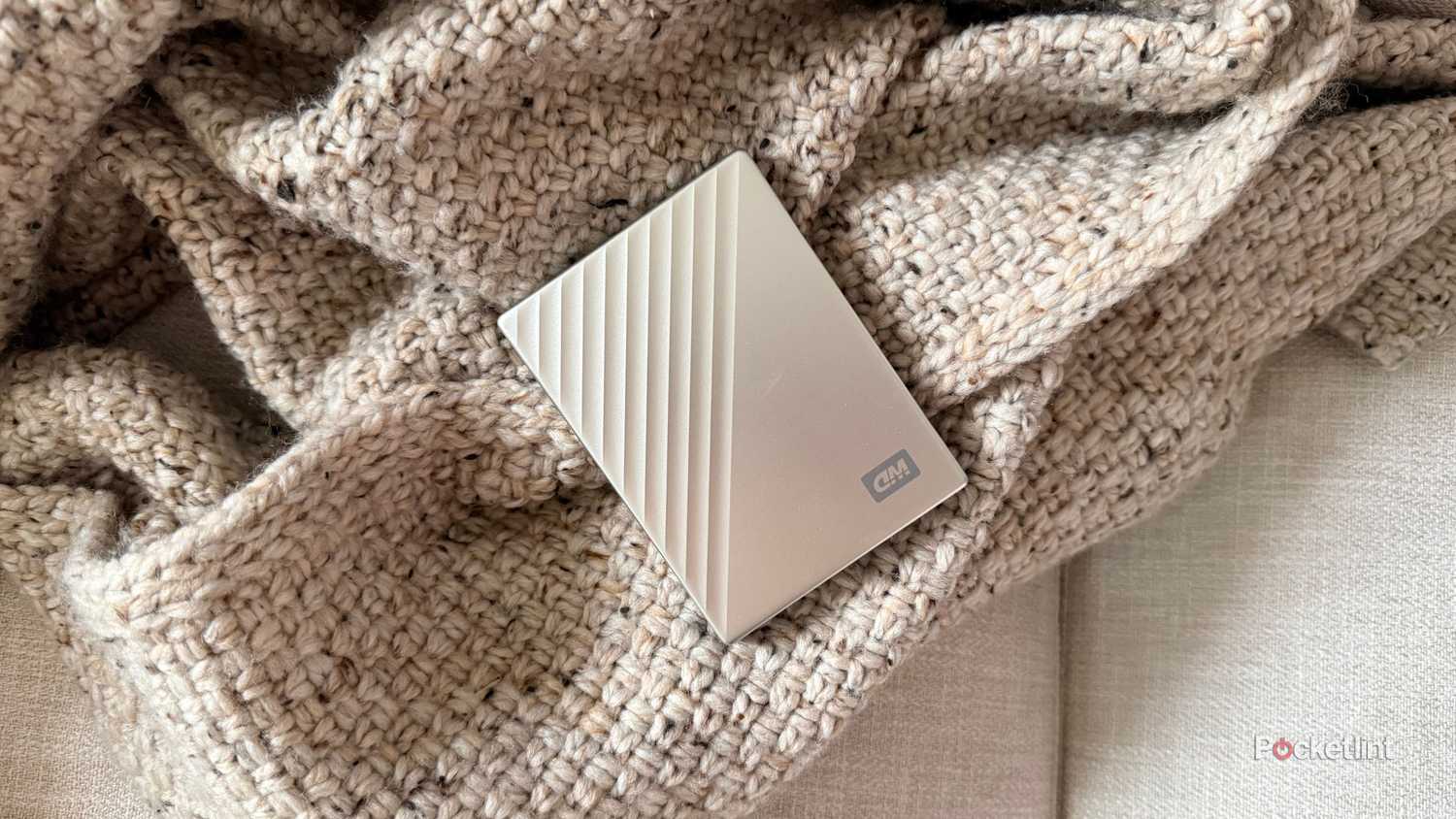 An external drive on a blanket. 