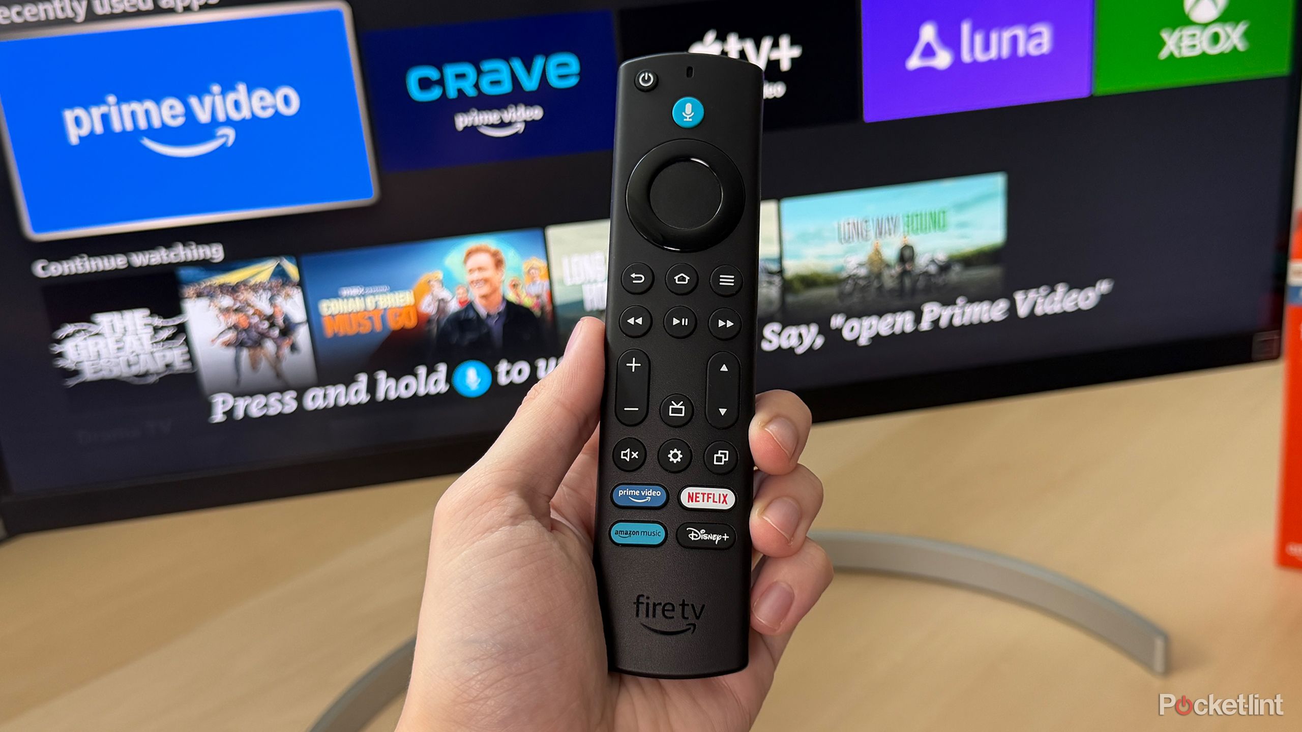 Fire TV remote in front of TV.