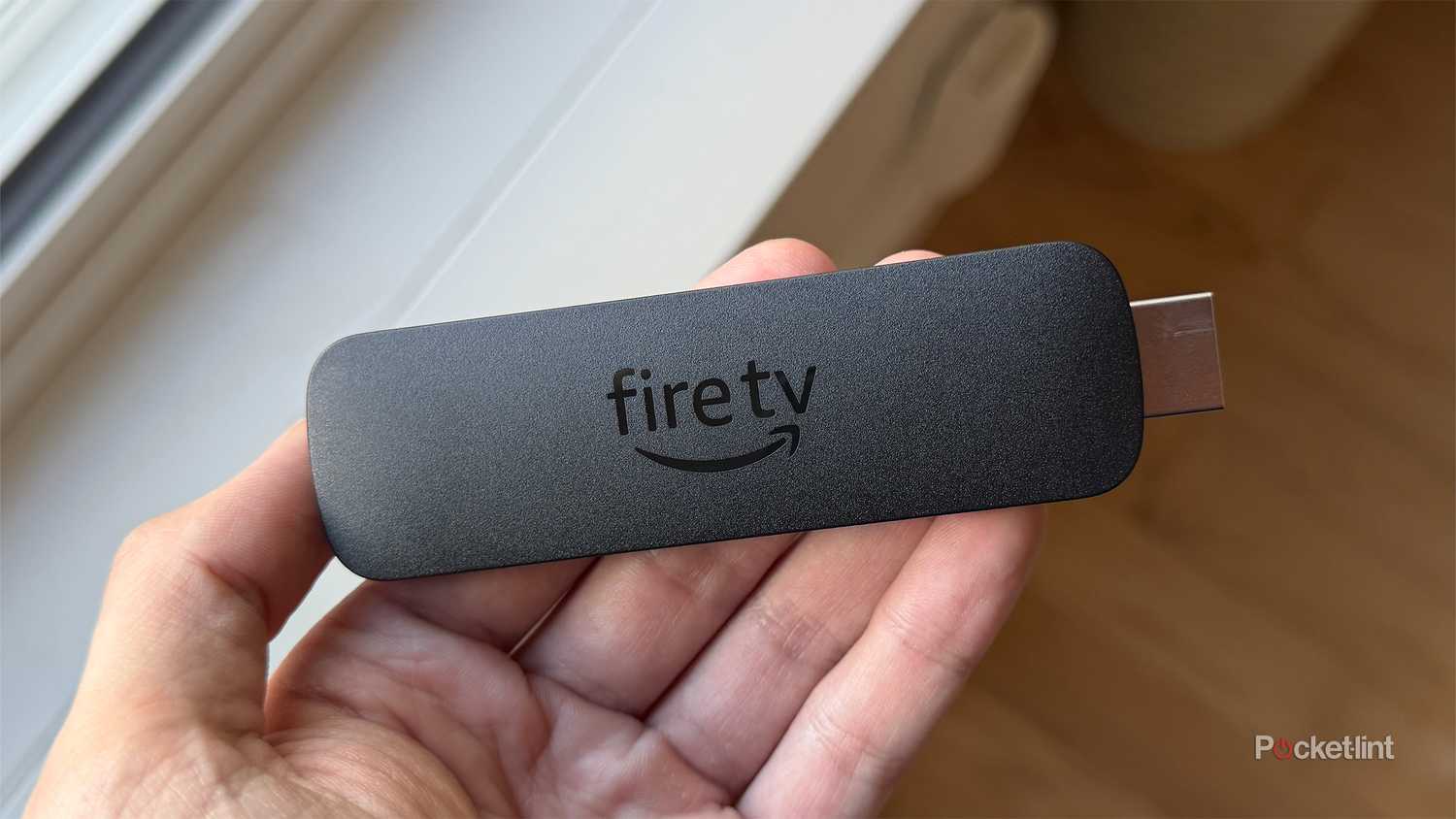 Person holding Amazon Fire TV Stick 4K Max.