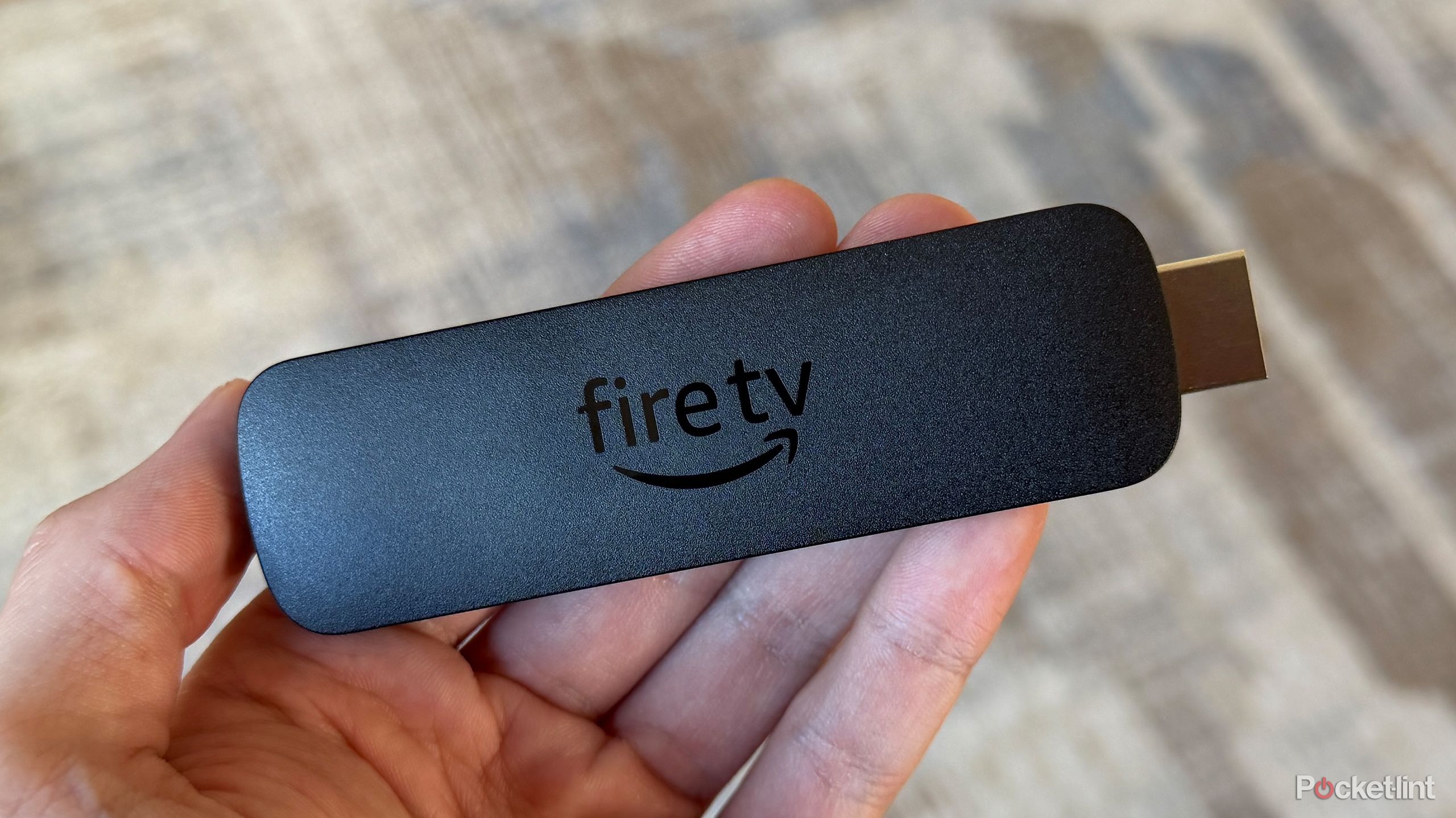 Amazon Fire TV Stick 4K Max in hand.