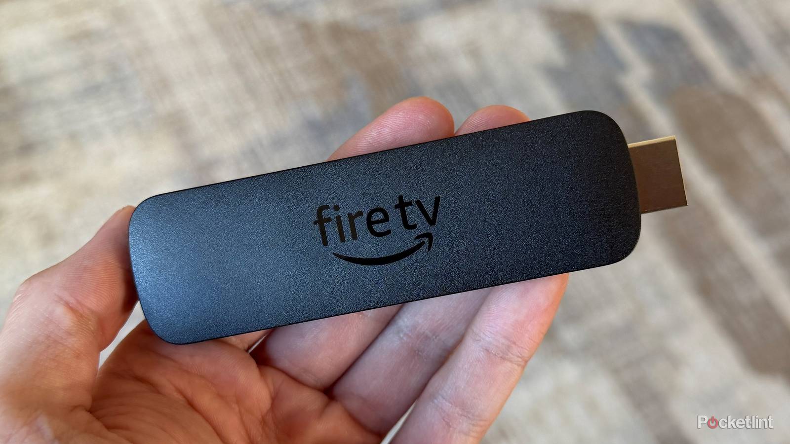Amazon Fire TV Stick 4K Max in hand.
