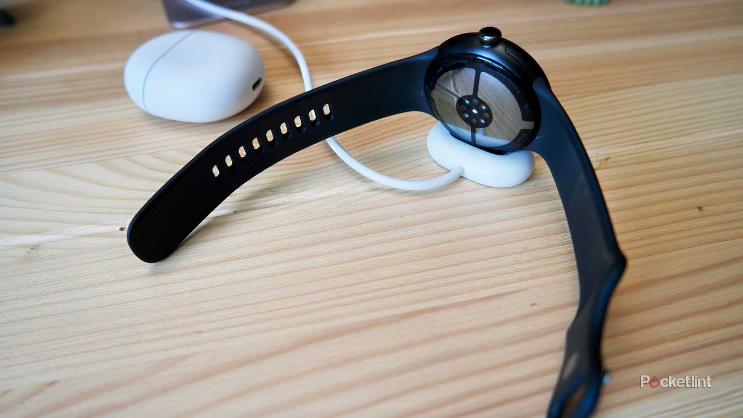 Google Pixel Watch 4 on the charger, rear view