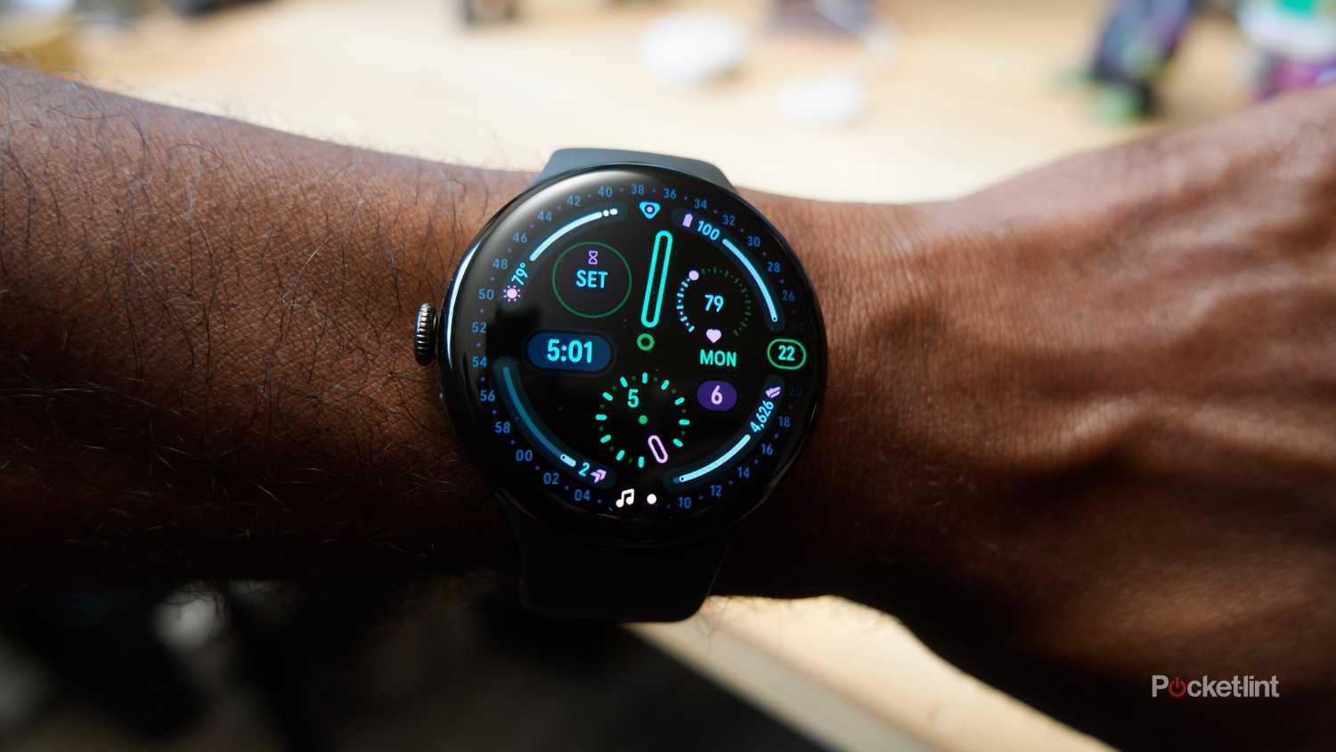 Google Pixel Watch 4 being worn, showing the Corsa watch face