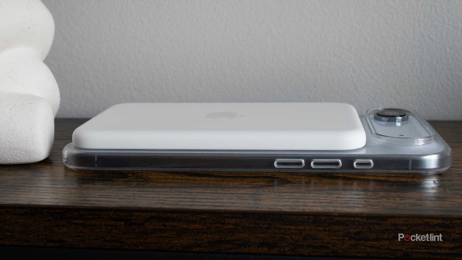 The iPhone Air sitting on its side with a MagSafe battery and case on it 