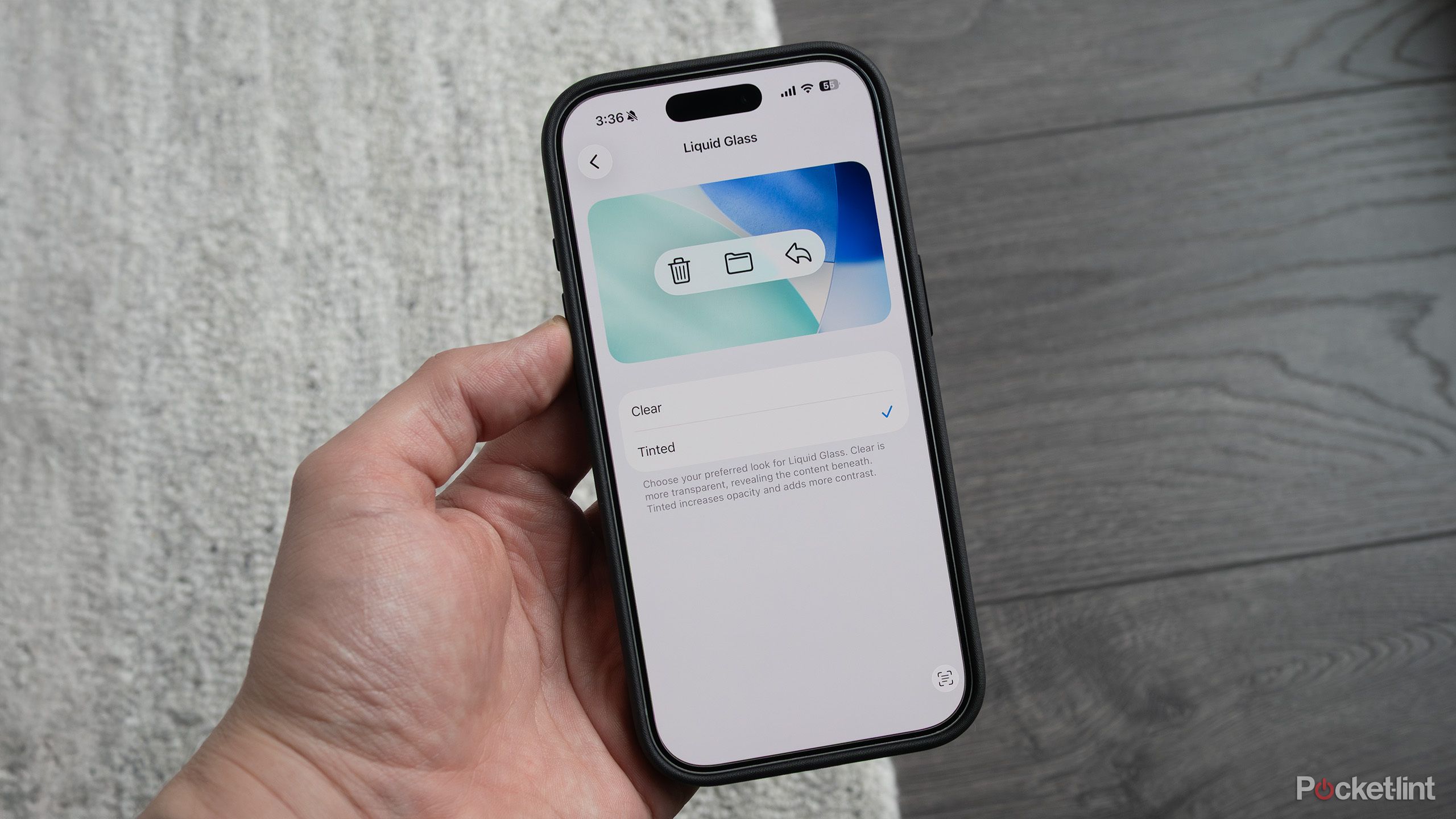Patrick holding an iPhone with Liquid Glass customization menu on. 
