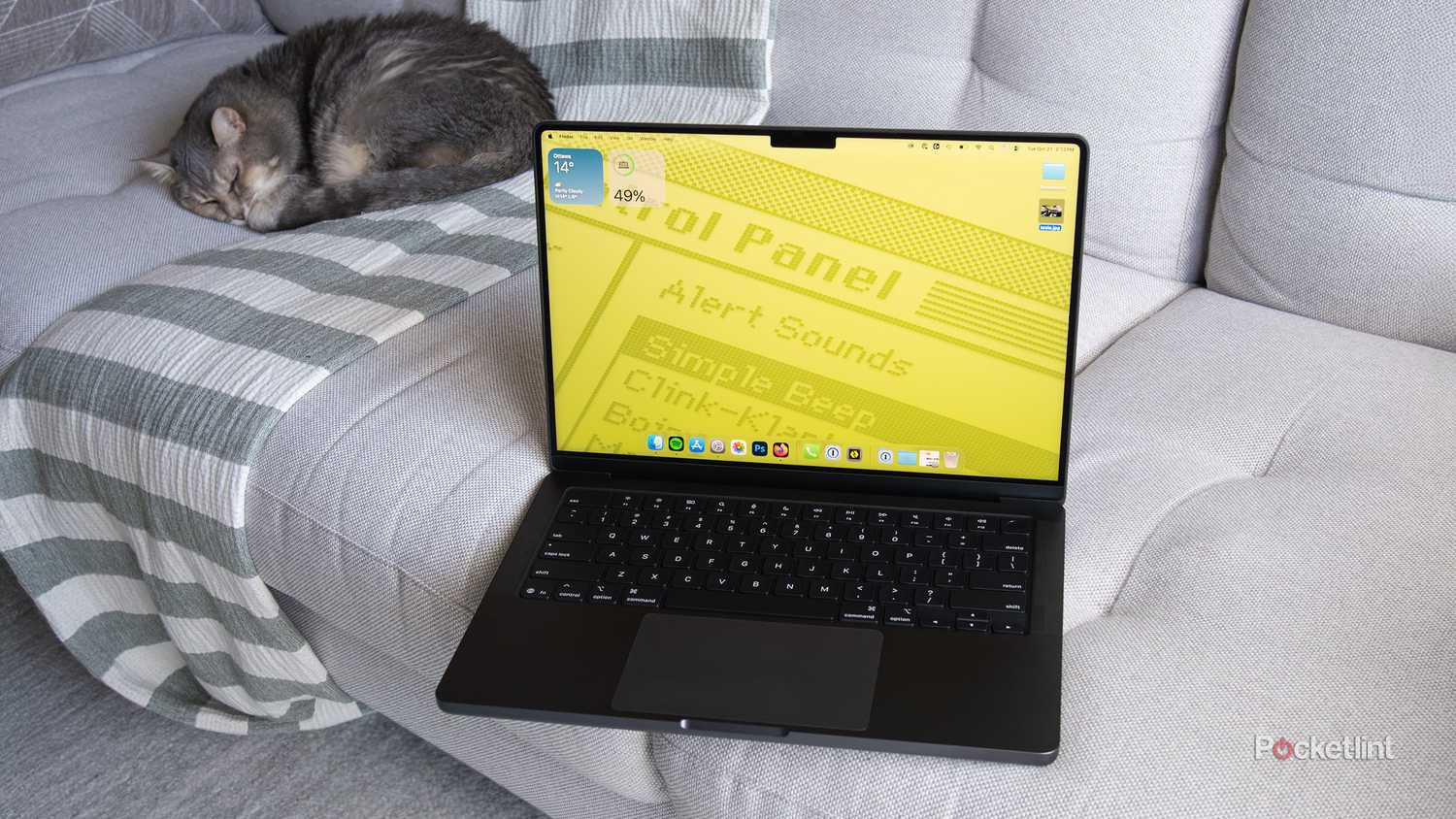 The M5 MacBook Pro sitting on a couch with a retro background 