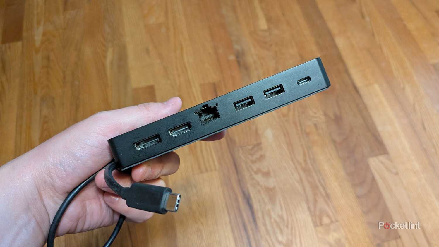 A person holding a USB-C hub.