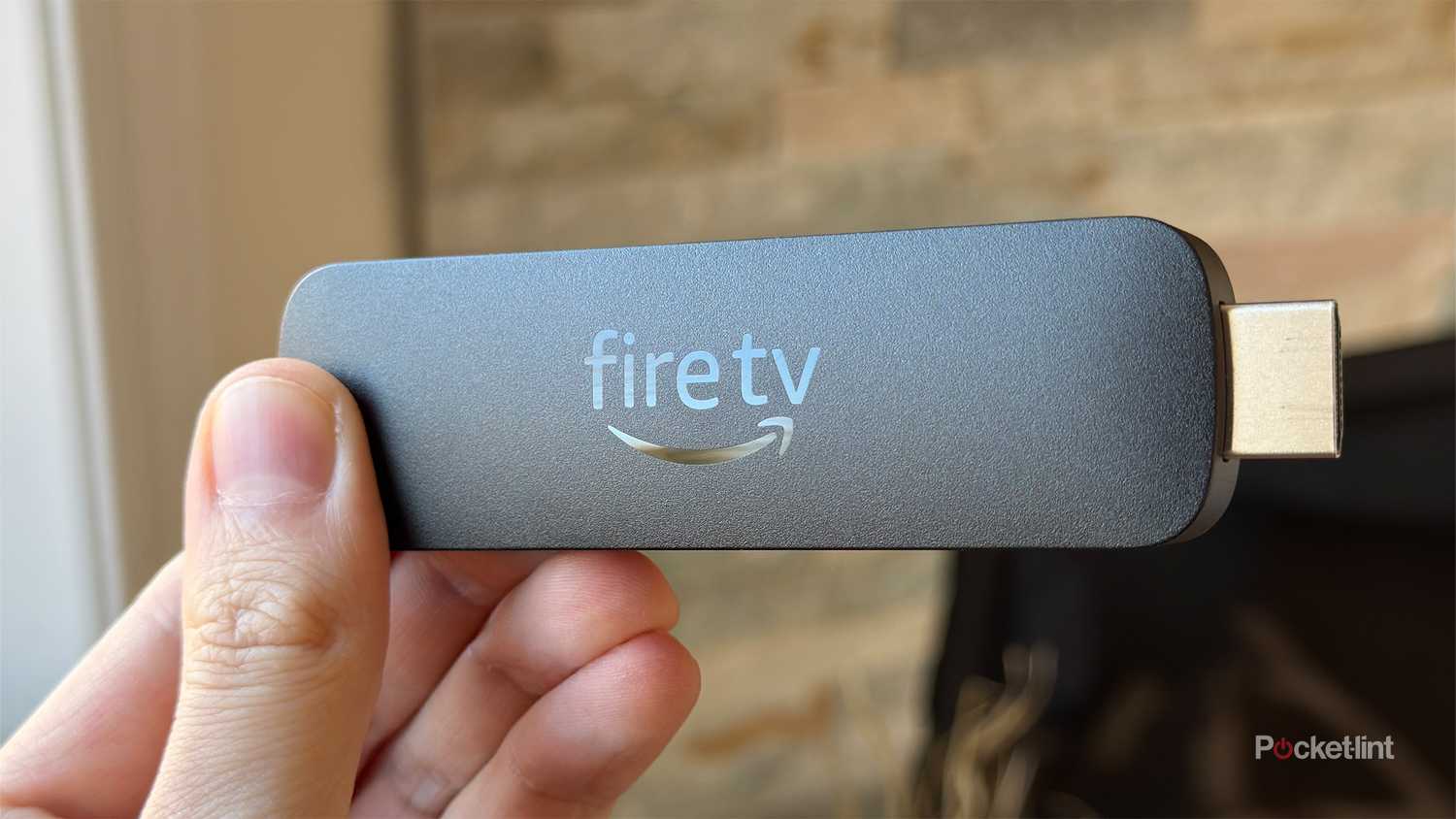 Person holding Fire TV Stick 4K Max.