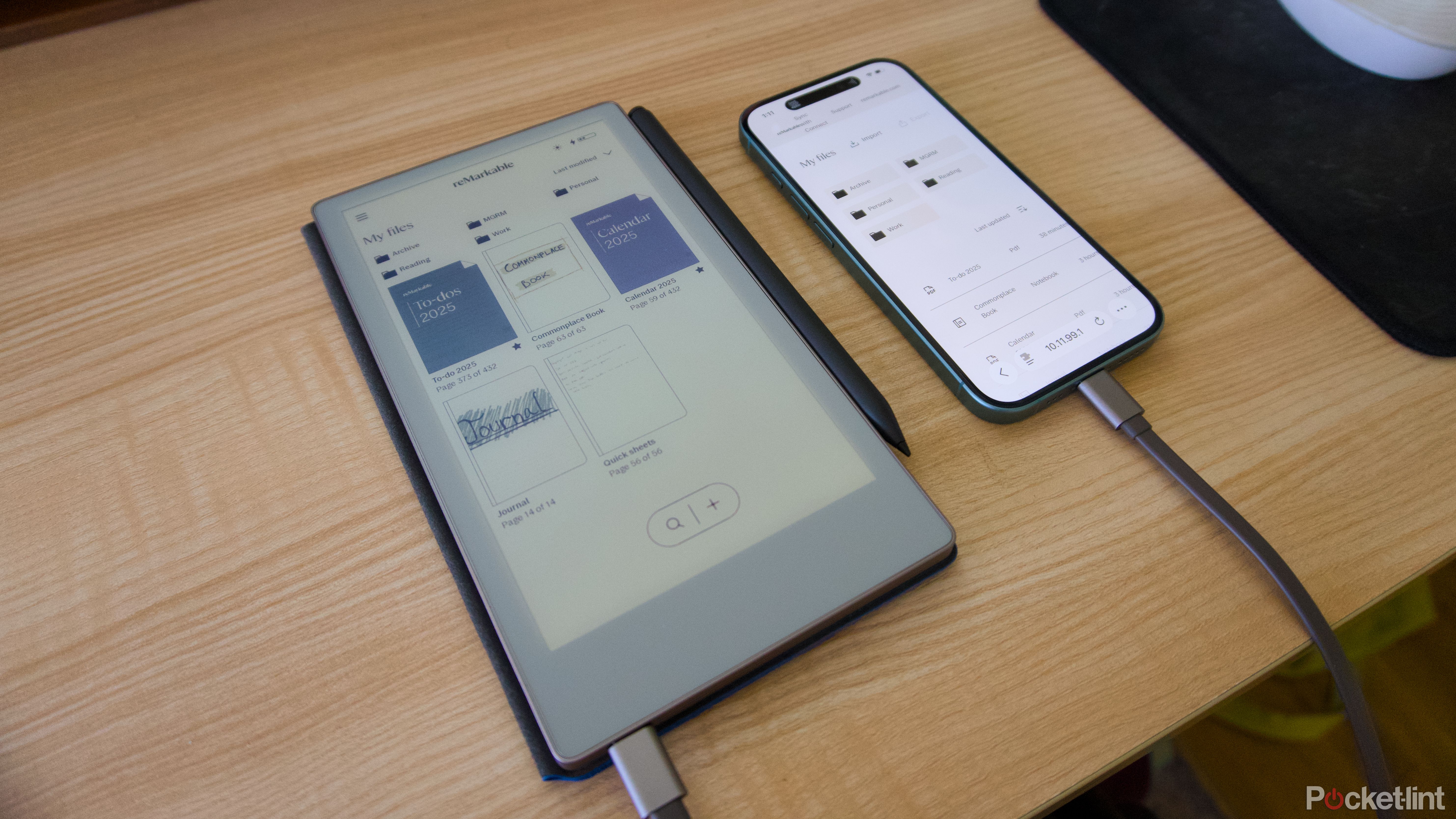 A reMarkable Paper Pro Move connected to an iPhone 16 with a USB-C cable.