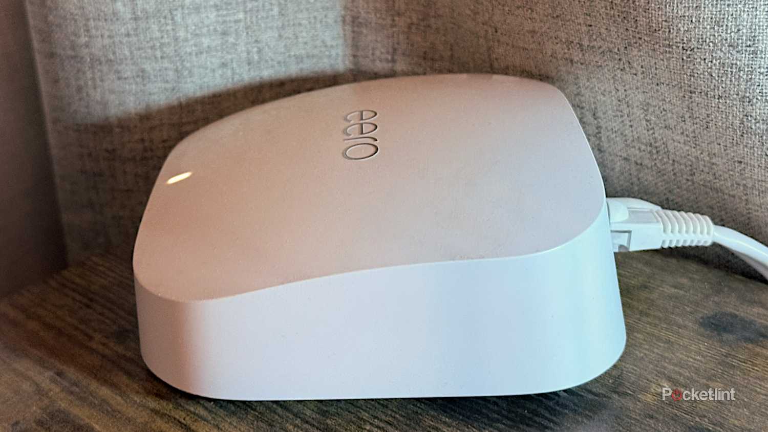 An Eero Pro 6E Wi-Fi router on a desk.