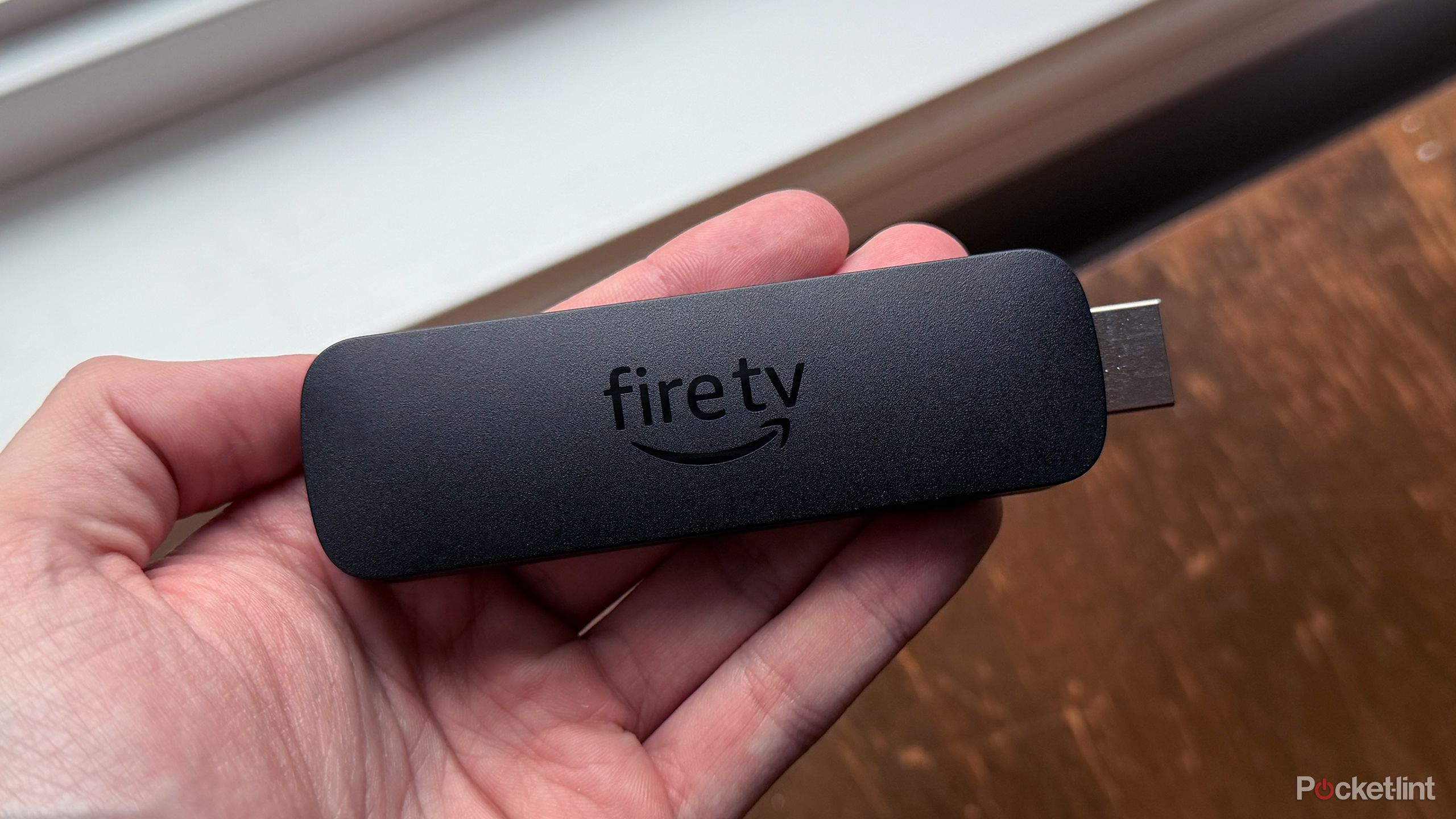 Person holding Fire TV Stick 4K Max.