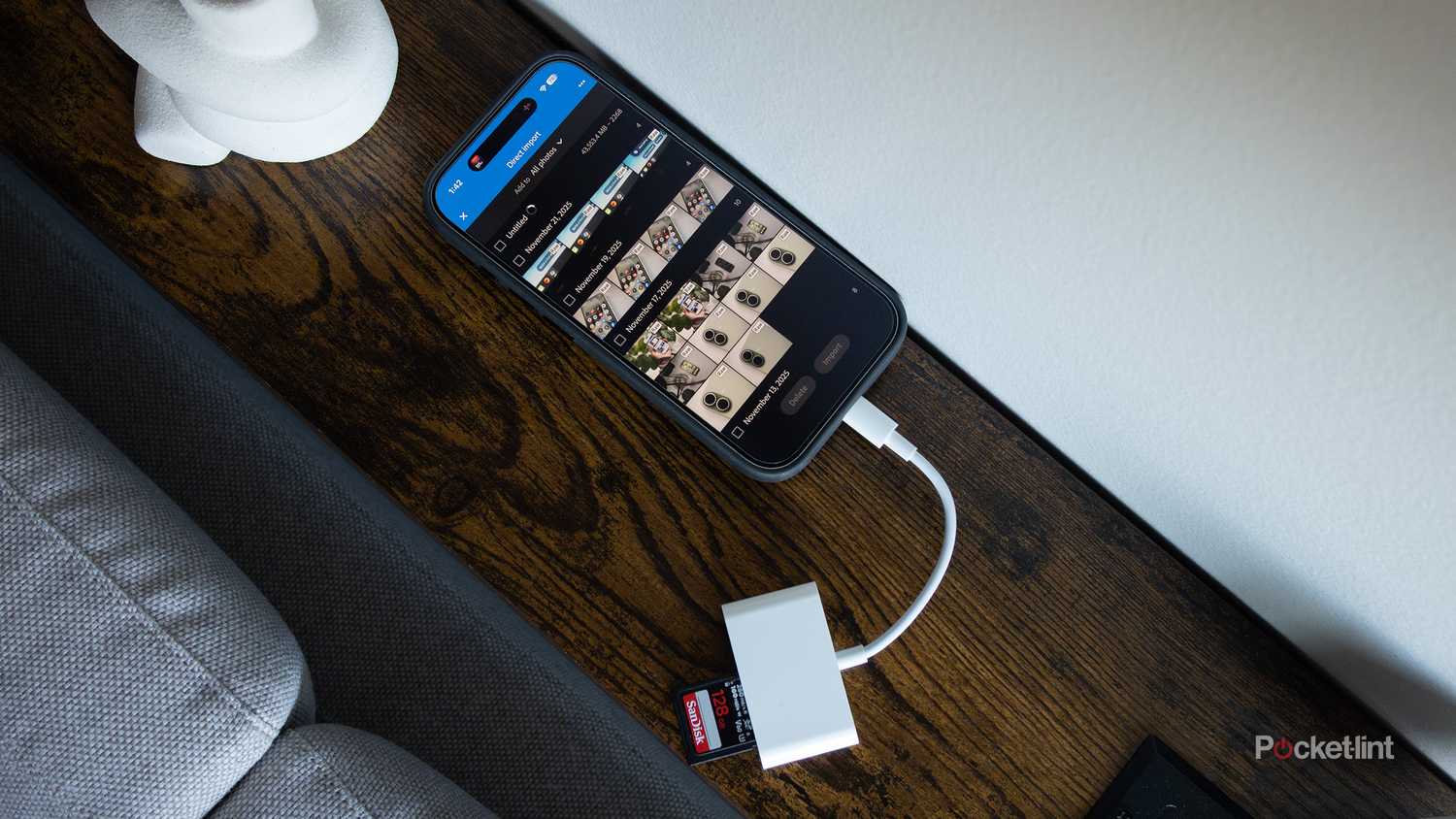 The iPhone 17 with a USB-C SD dongle plugged into it