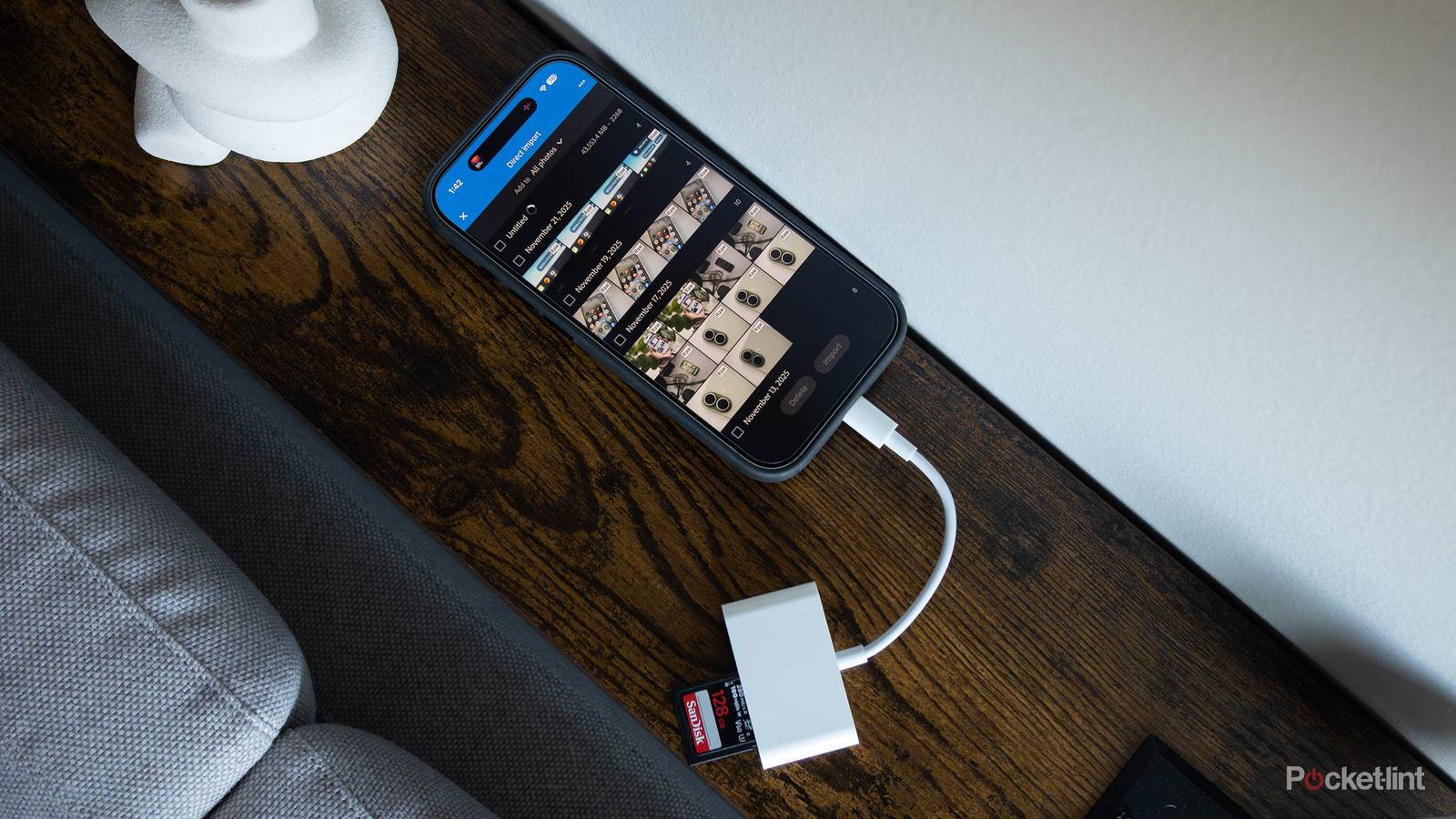 The iPhone 17 with a USB-C SD dongle plugged into it