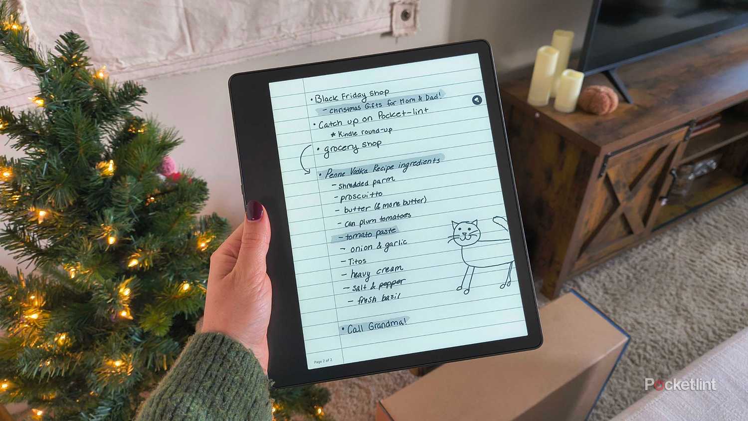 A Kindle Scribe in hand. 