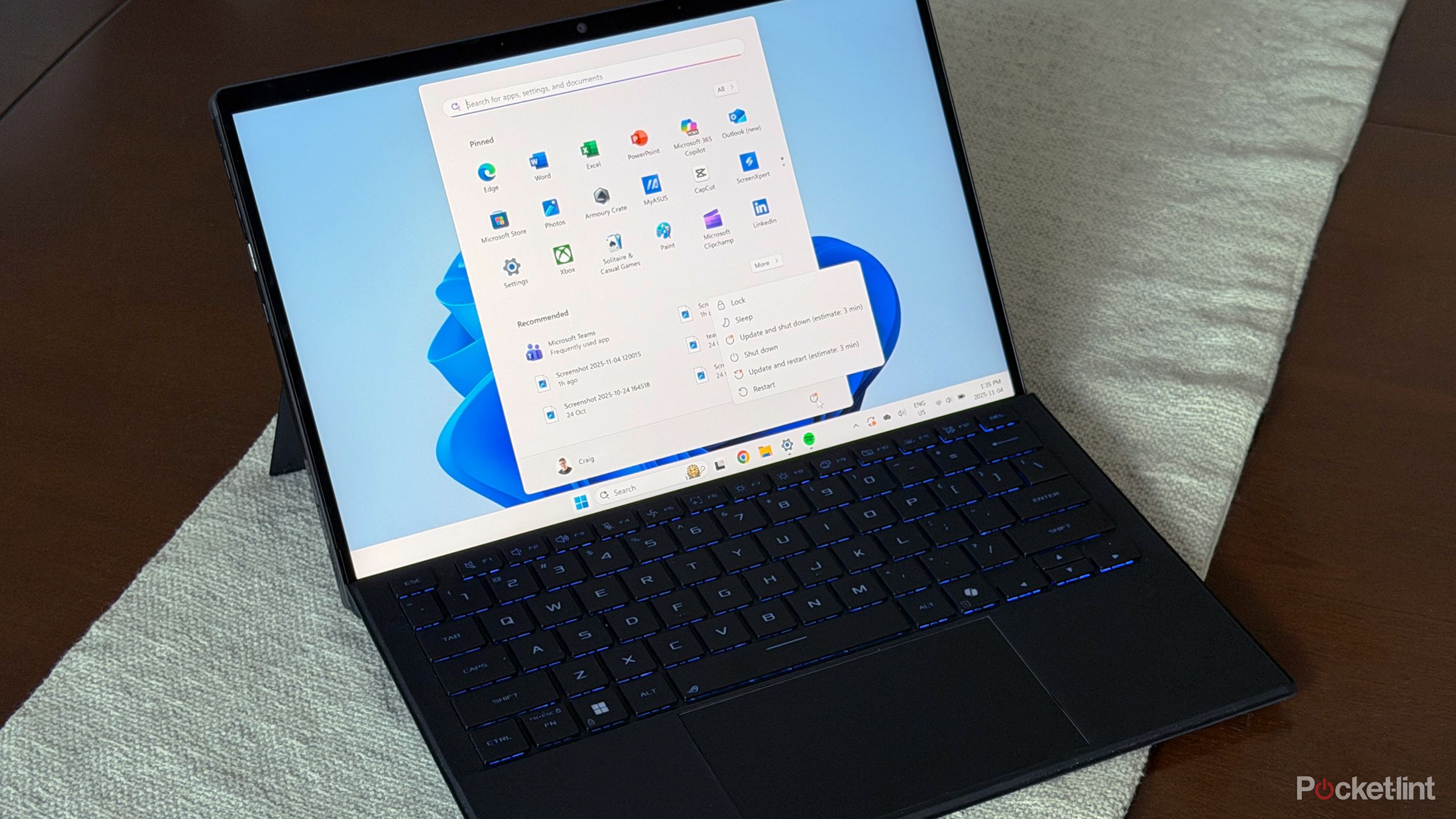 Windows Start Menu on Windows 11 laptop on table.