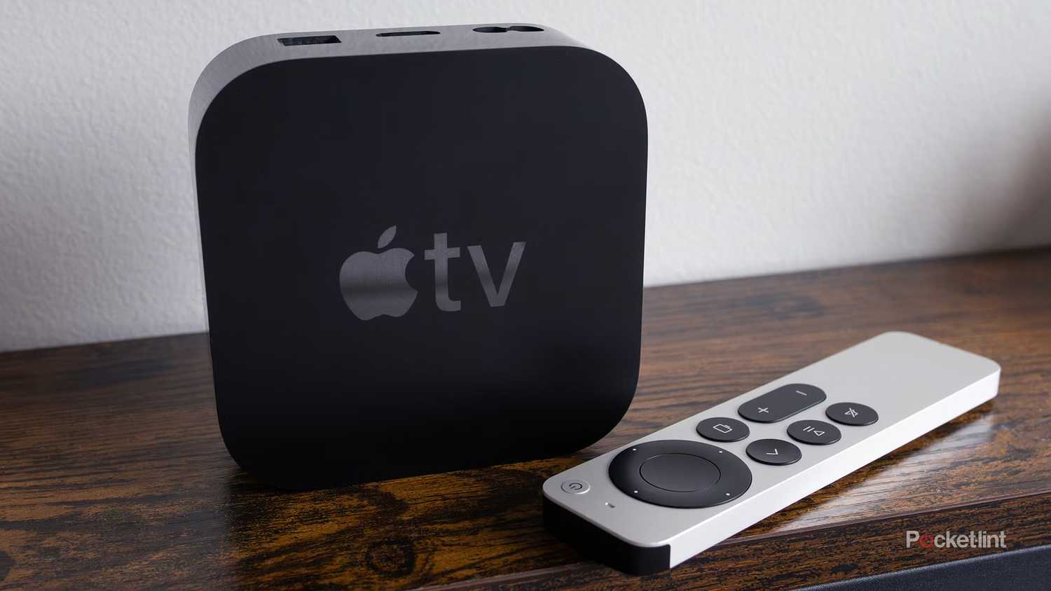 Apple TV 4K and remote on table.