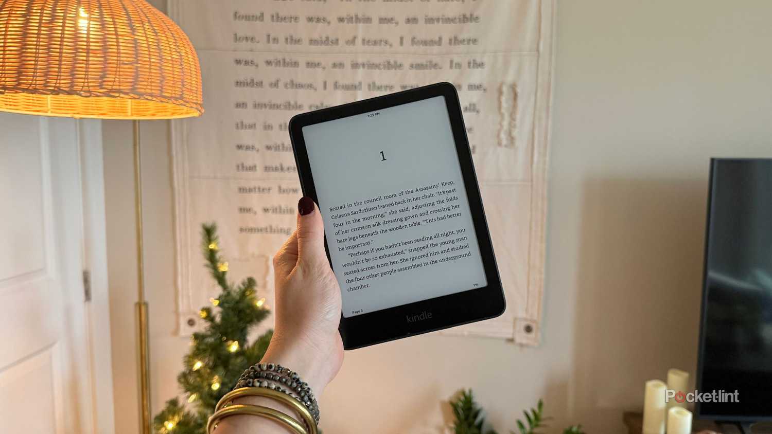 Holding a Kindle Paperwhite. 