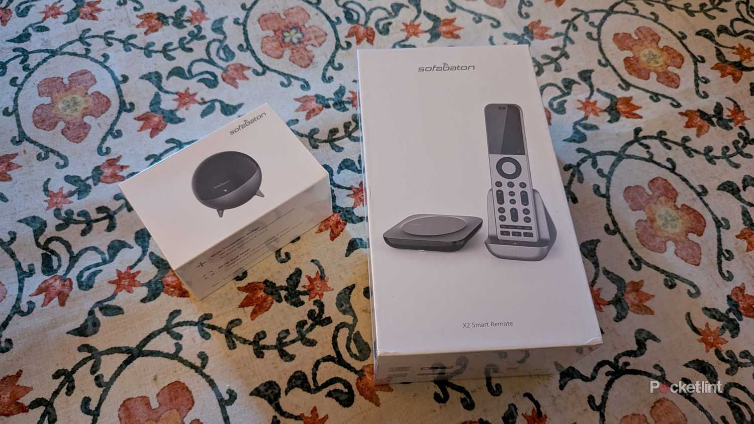 A SofaBaton X2 remote with the R1 transmitter.