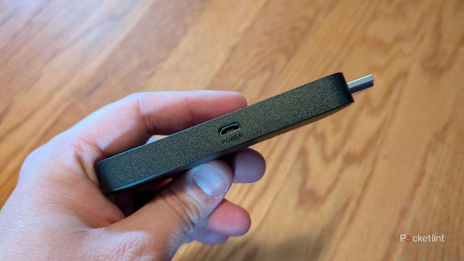 A person showing the power port on an Amazon Fire TV Stick 4K Select.