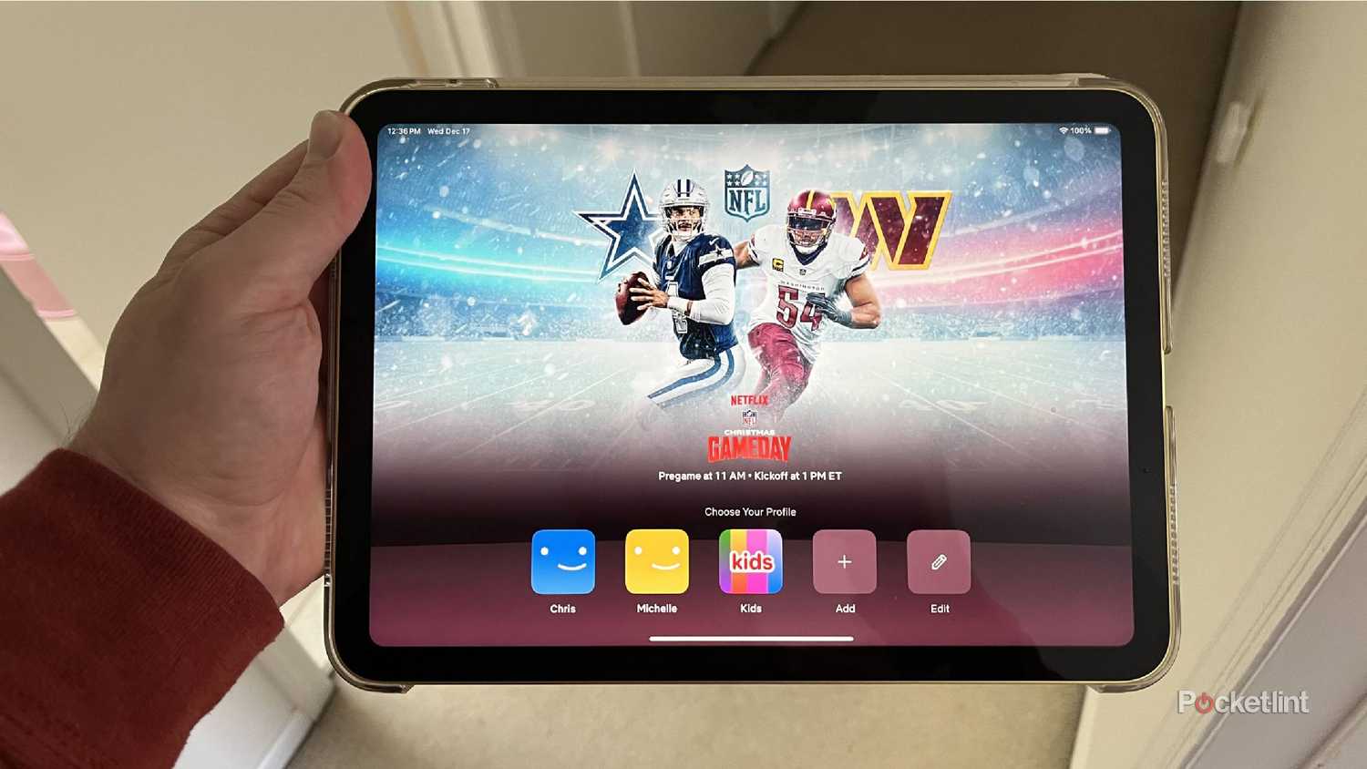 An iPad being held showing the Netflix home screen.