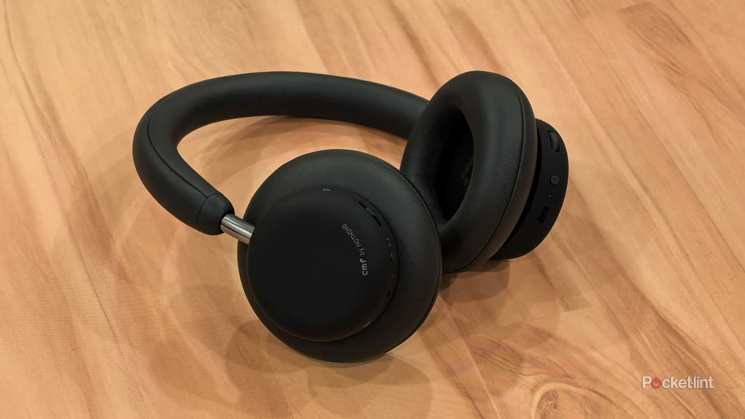 Close up shot of the CMF Headphones Pro on a wooden table