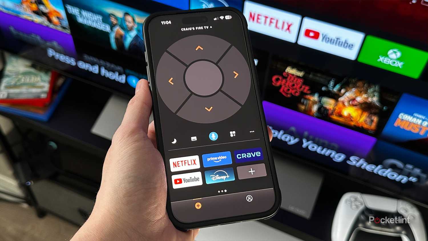 Person holding phone with Fire TV app.