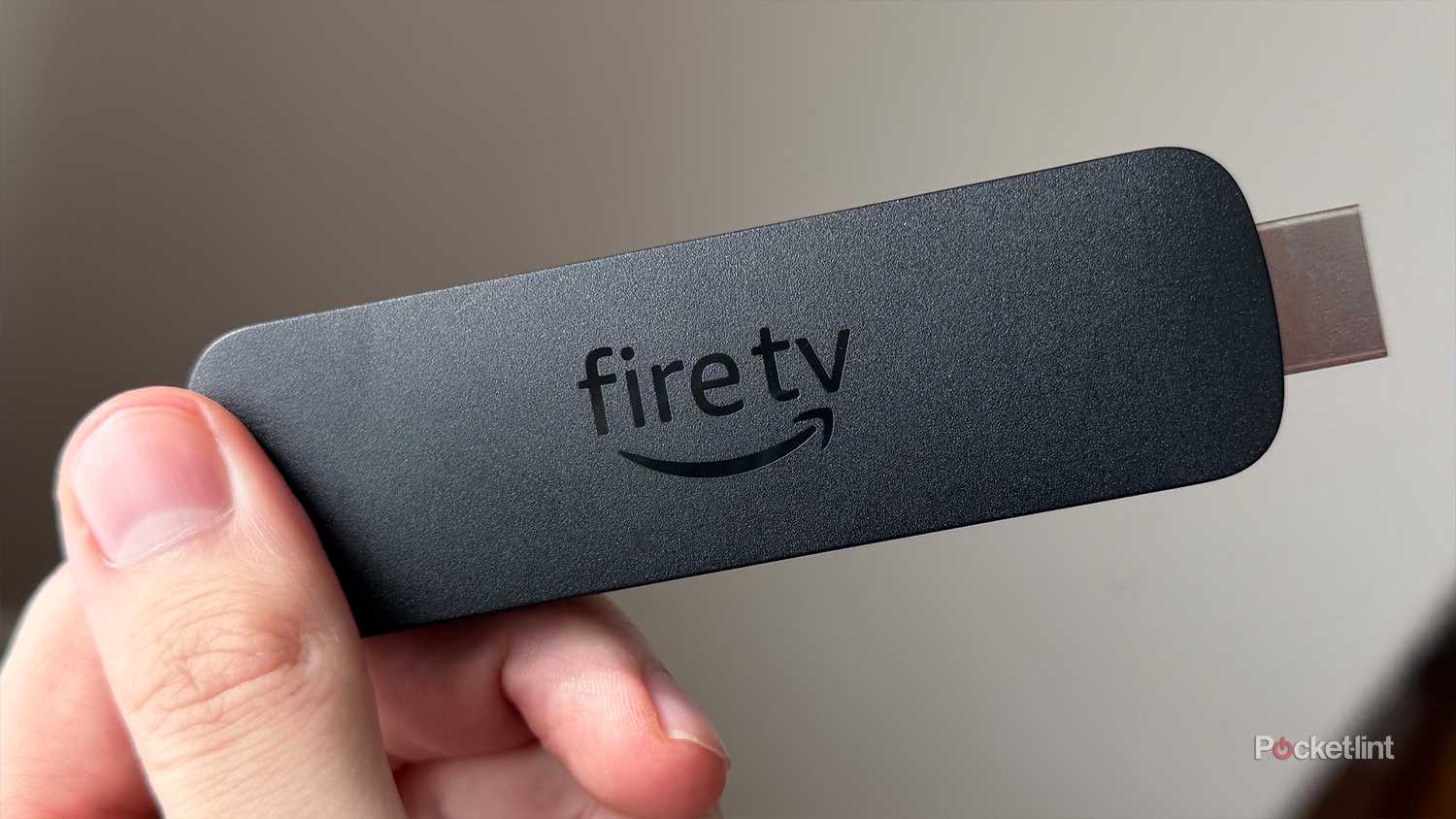 Person holding Fire TV Stick 4K Max.