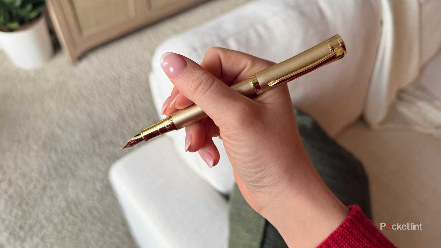 Holding a fountain pen. 