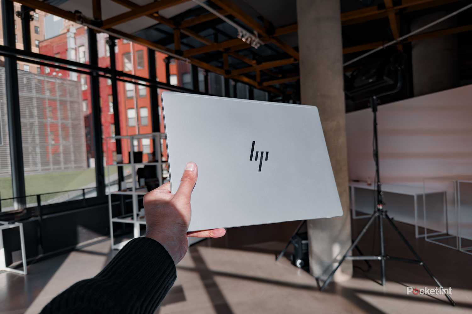 HP-Omnibook-14-Ultra-in-hand-against-studio-background