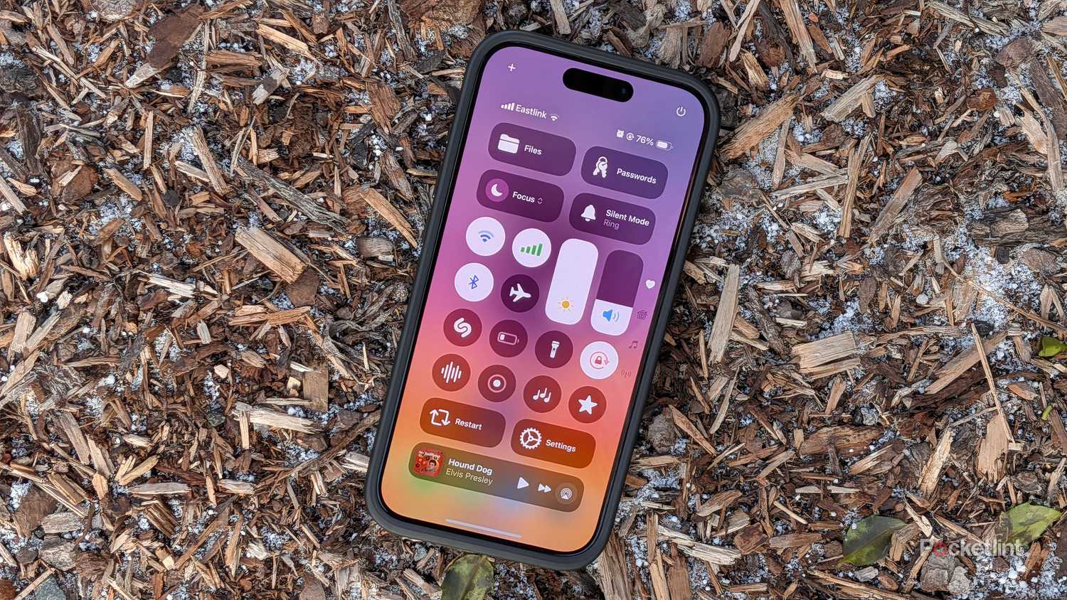 The iOS 18 quick settings panel on an iPhone 15 Pro.
