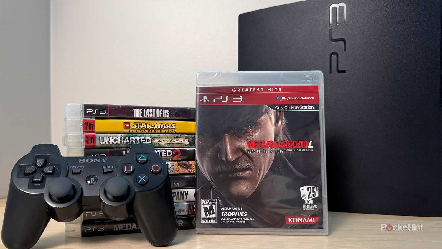 PS3 games next to PS3 console.