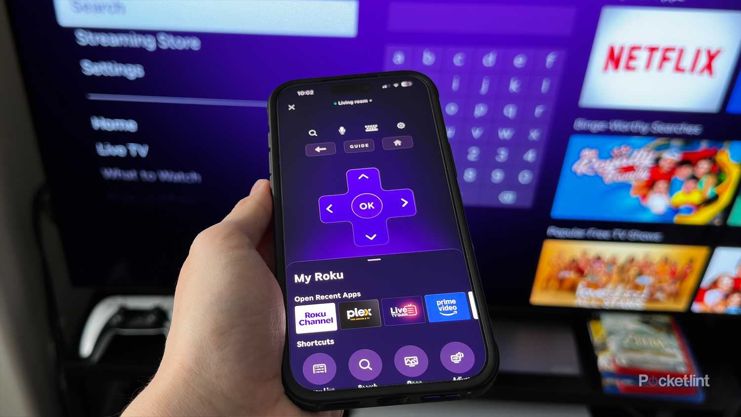 Person using Roku mobile app.