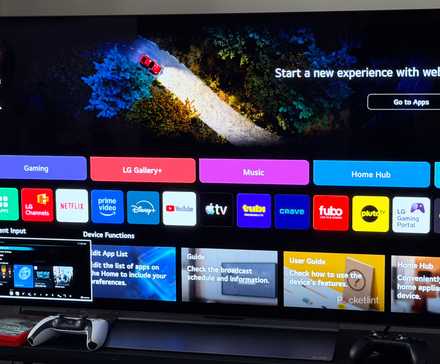 LG TV with PS5 and Nintendo Switch controllers beside it.